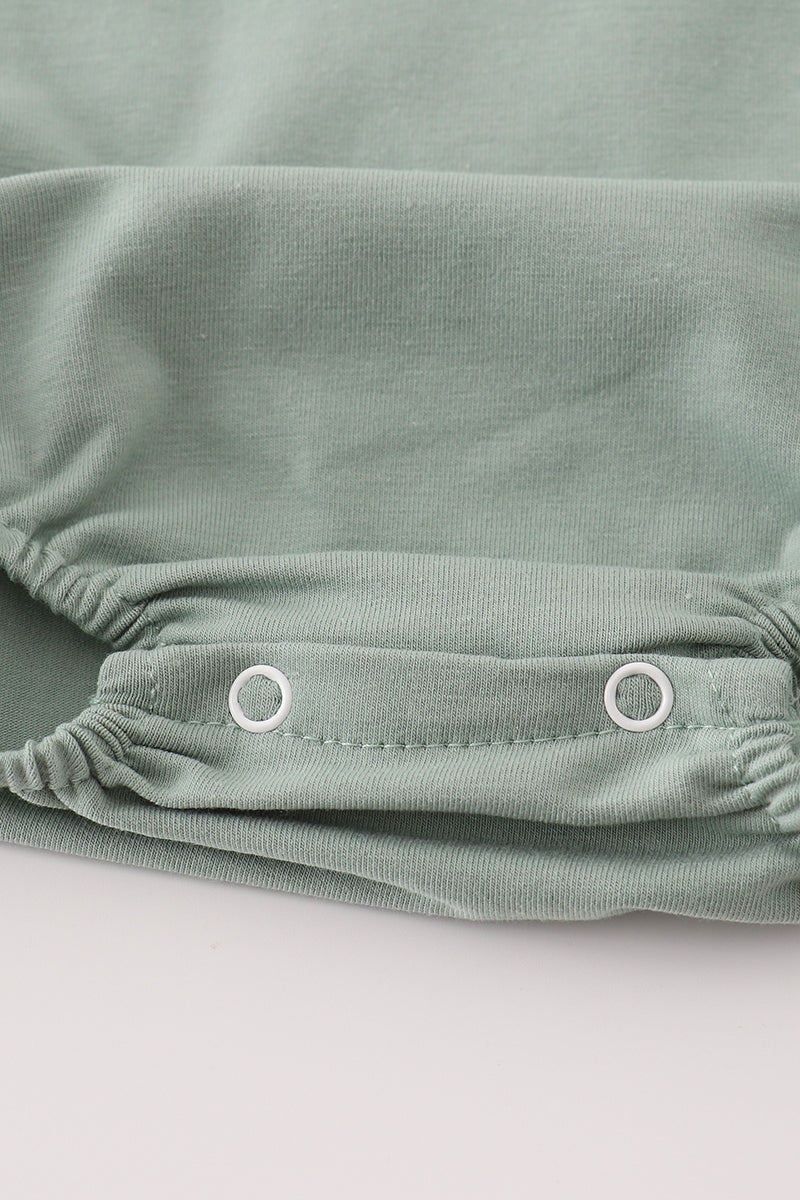 Green character applique bubble